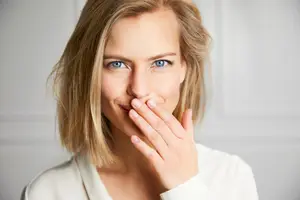 woman covering her mouth with her hand