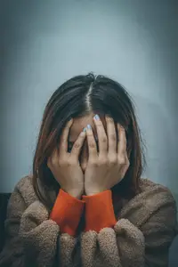 frustrated woman with her head in her hands