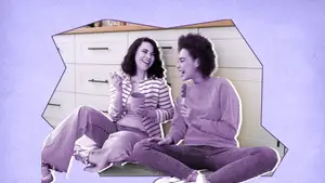 two women eating ice cream and laughing together