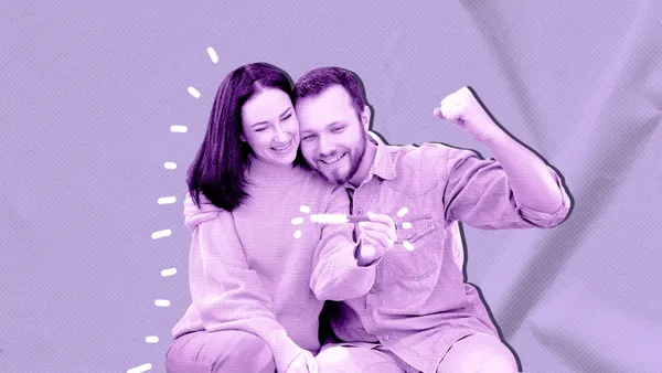 couple with positive pregnancy test celebrating