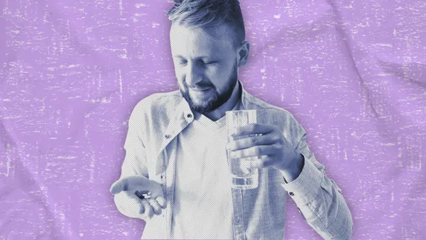 man taking prenatal vitamins