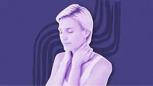 woman feeling for lumps on her thyroid