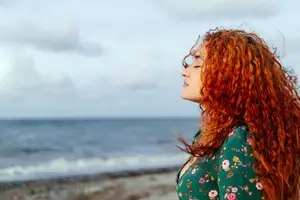 woman meditating at the beach