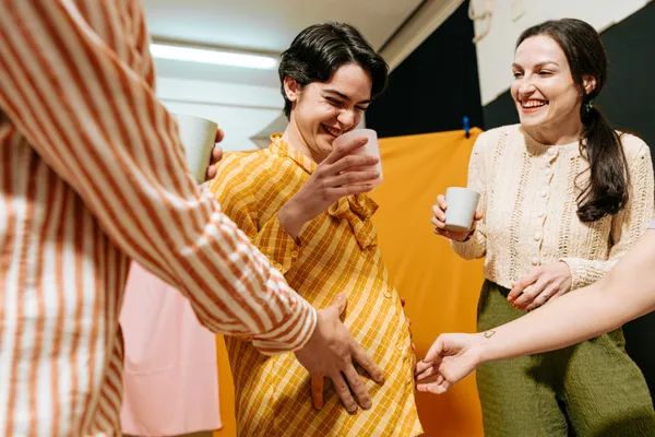 surrogate with big baby bump enjoying attention from her friends