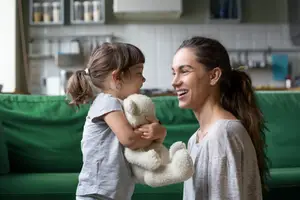 woman playing at home with her young daughter