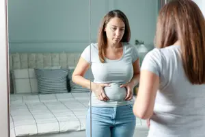 woman-looking-at-belly