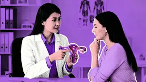 doctor showing an anatomical model of a uterus to her patient