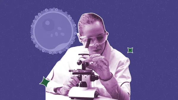 embryologist looking through a microscope