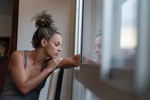 woman with ptsd staring out the window