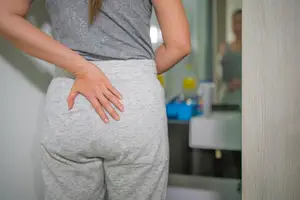 woman experiencing butt cramps during her period