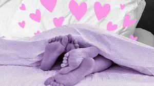 woman being kissed in bed
