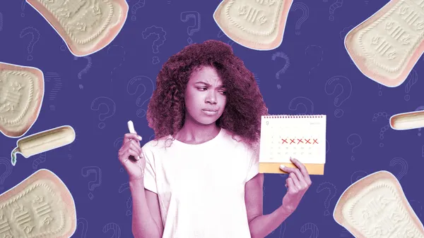 woman looking at a calendar wondering why her period is delayed