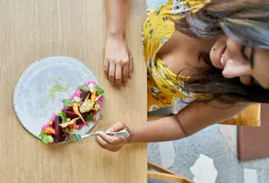 woman eating according to the autoimmune protocol diet