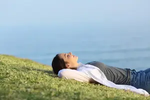 woman meditating by the sea
