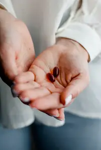 woman holding prenatal vitamins