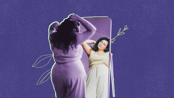 woman looking at herself in the mirror