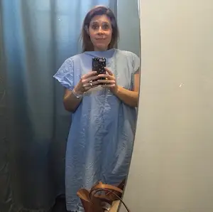 secondary infertility warrior ali prato taking a selfie in a hospital gown