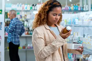 woman-looking-at-supplement-bottle
