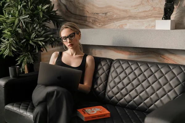 woman working on the sofa in her office