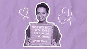 woman holding sign about the two week wait with a gestational surrogate