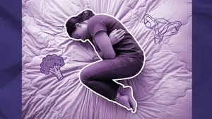 woman with endometriosis pain in fetal position on her bed