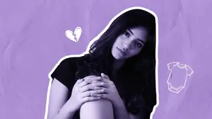 sad woman leaning against a wall
