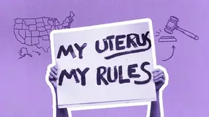 reproductive rights activist holding a sign that reads "my uterus my rules"