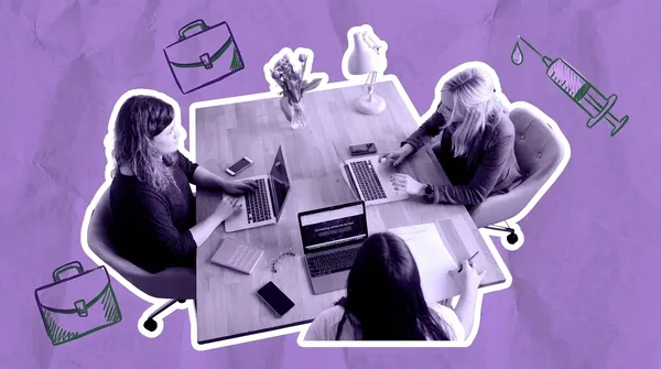 three women working on laptops at a table