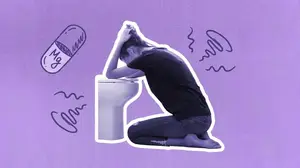woman with morning sickness bent over the toilet
