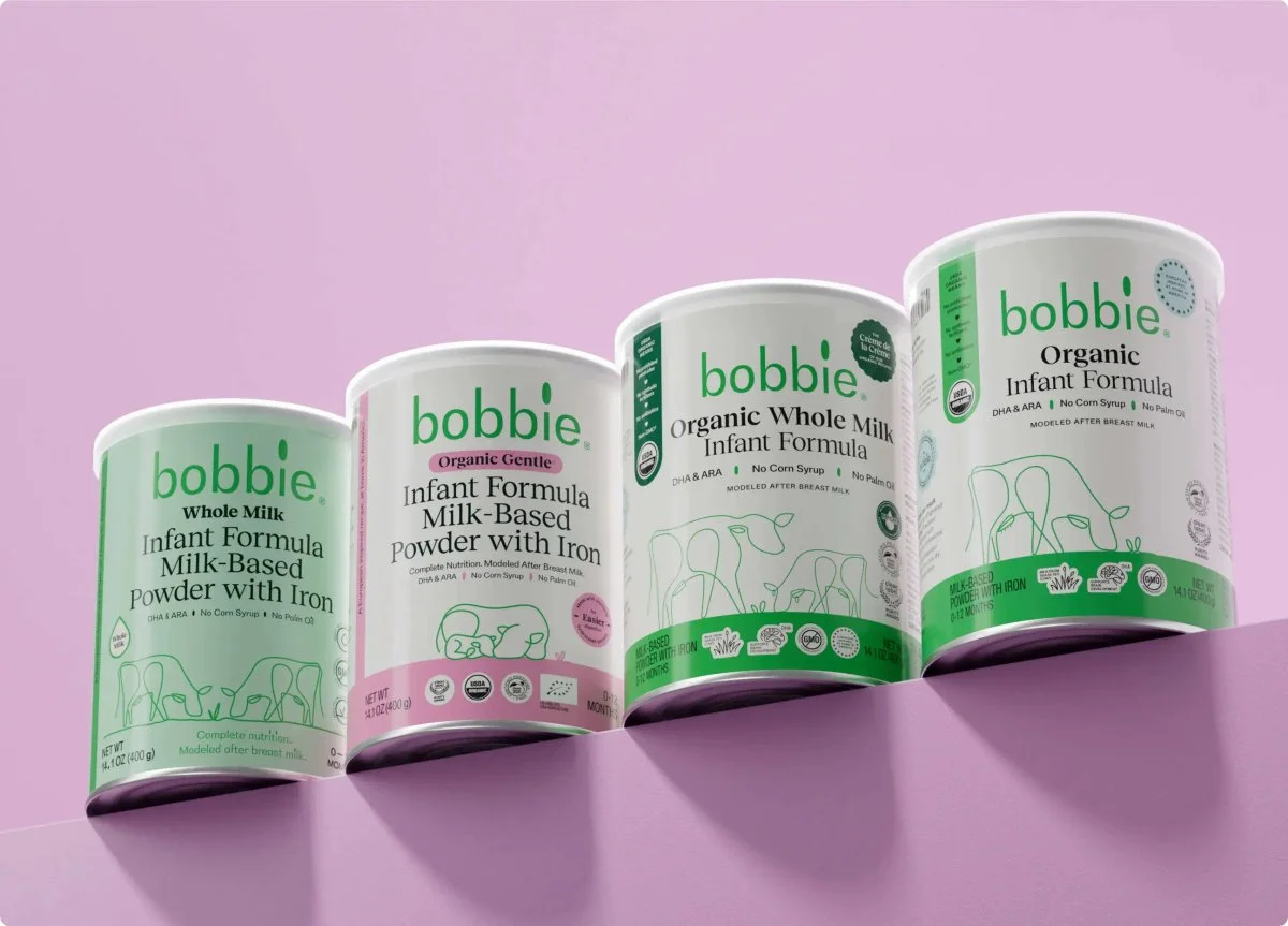 Four cans of Bobbie infant formula: Whole Milk, Organic Gentle, Organic Whole Milk, and Organic