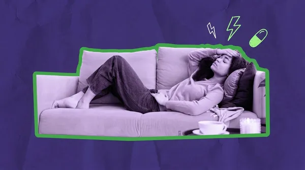 woman supine on the sofa having a period migraine