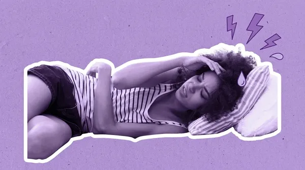 woman laying on the sofa trying to manage a migraine